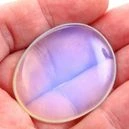 A person holding an opalite crystal