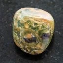 A polished rhyolite on a black granite