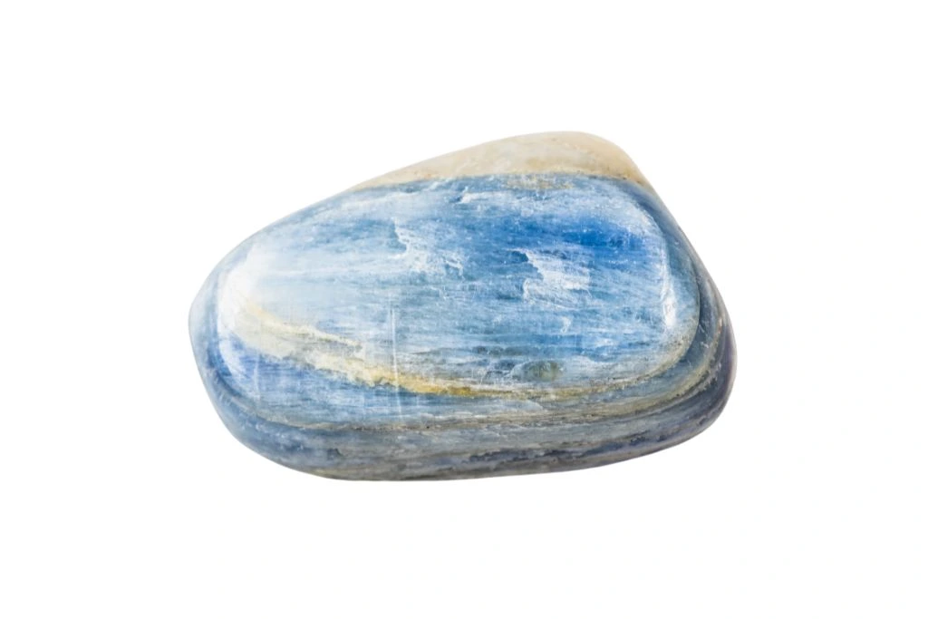 polished kyanite crystal on a white background