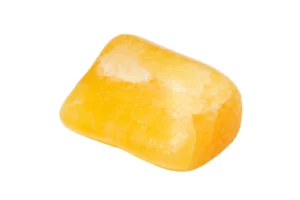 A polished orange calcite on a white background