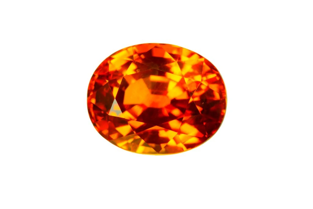 Polished Orange sapphire on a white background