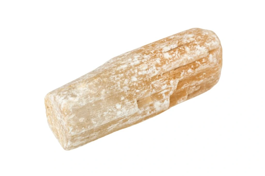 Raw orange selenite on a white background