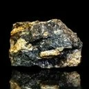 Sphalerite on a black background with reflection below