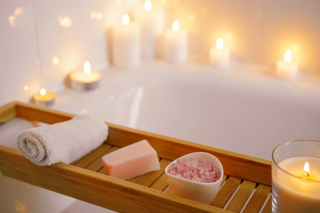 Crystals, candles soap and towel on the bathtub