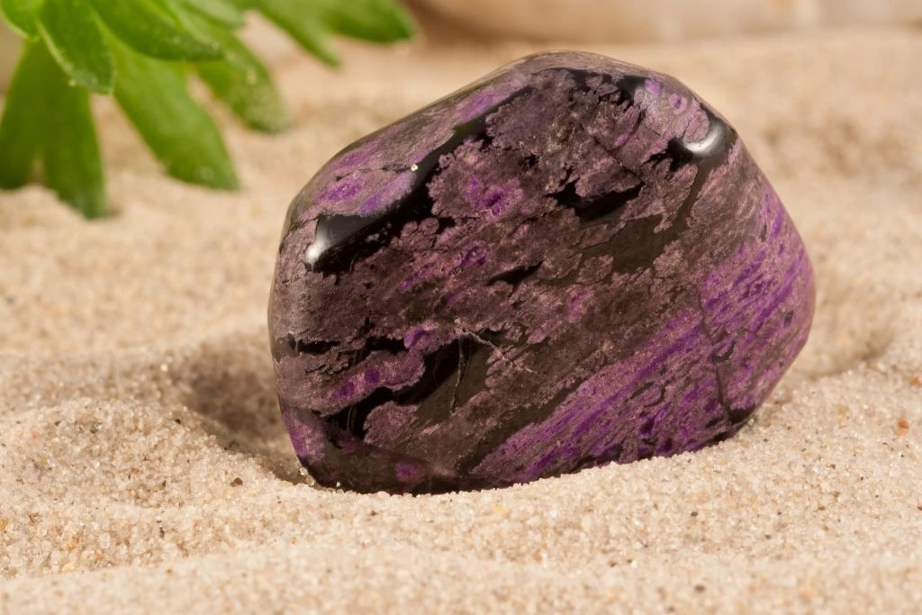 Sugilite crystal on the sand