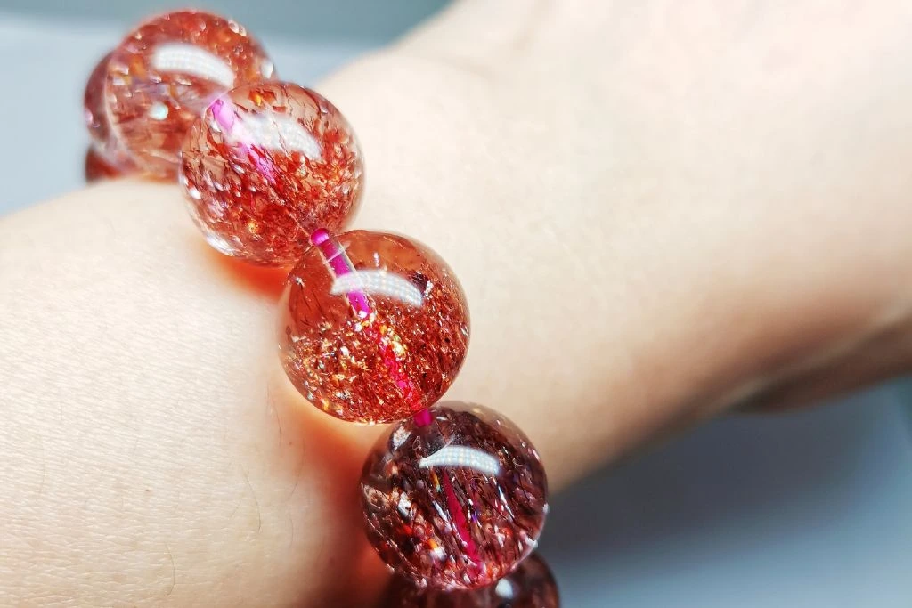 A super seven crystal bracelet on a person's wrist