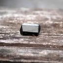 a tourmaline crystal on a wooden table