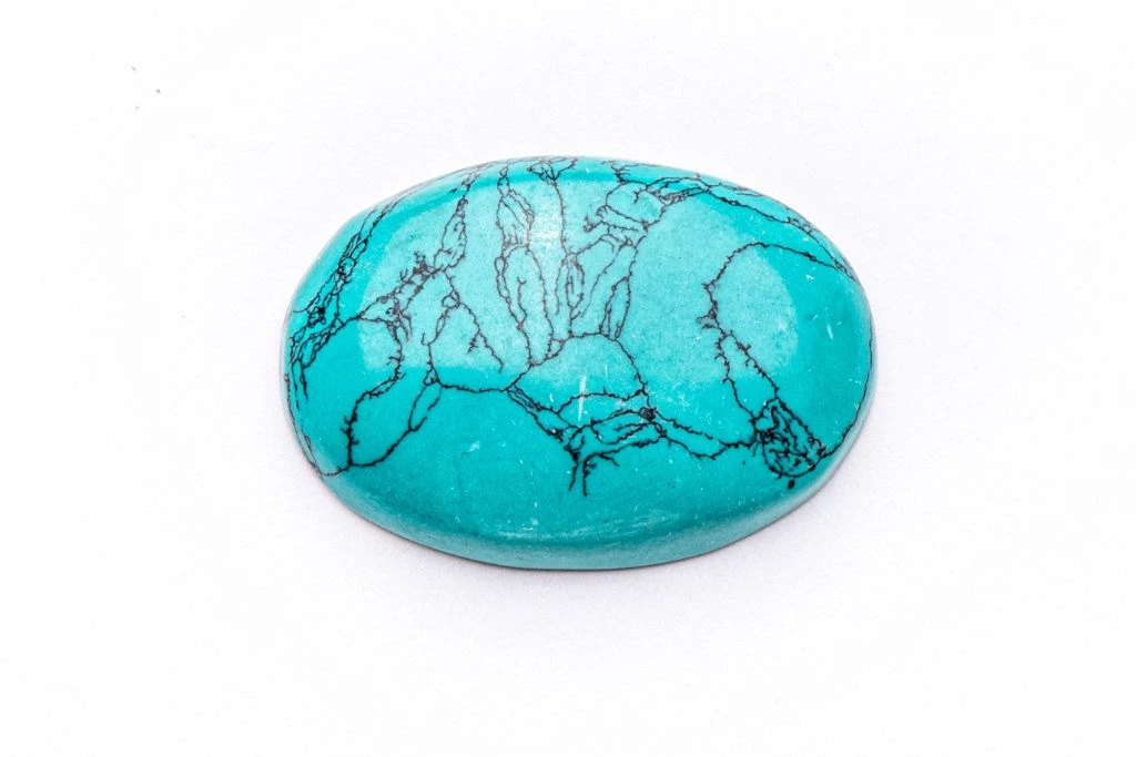 A polished Turquoise crystal on a white background