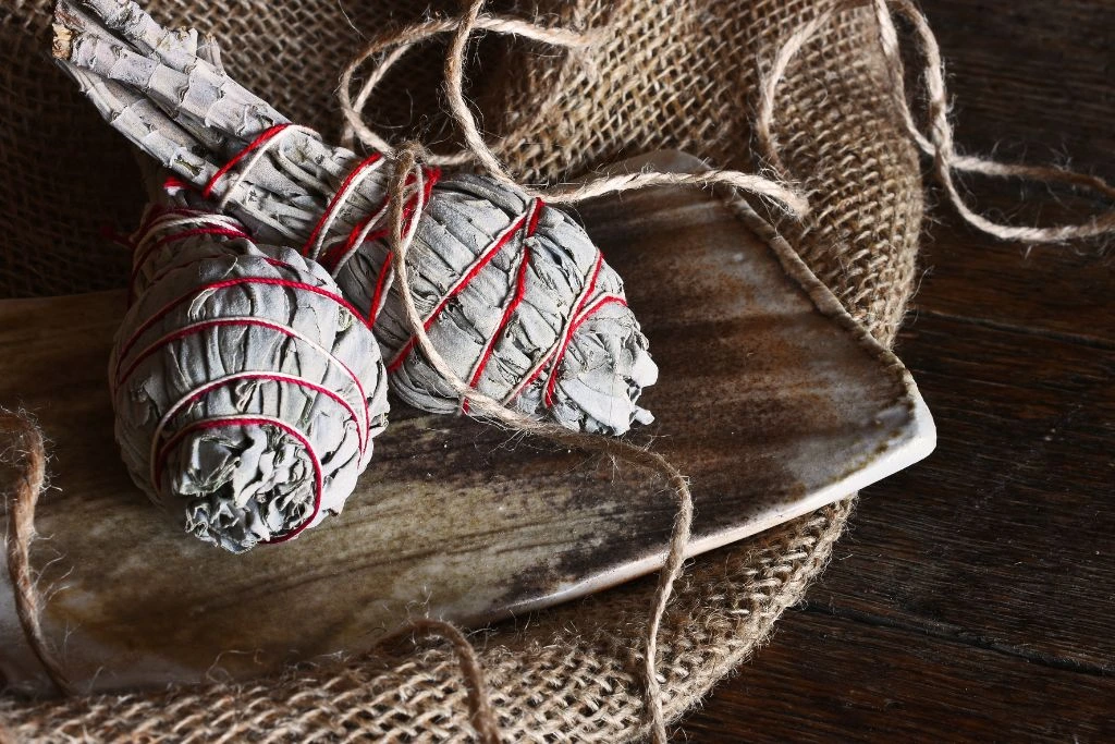 2 pieces of white sage smudge stick on a wood