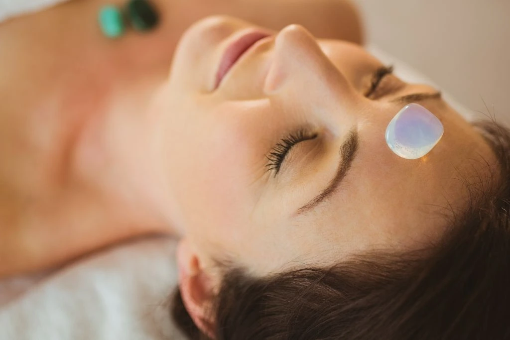 A polished crystal on a woman's forehead