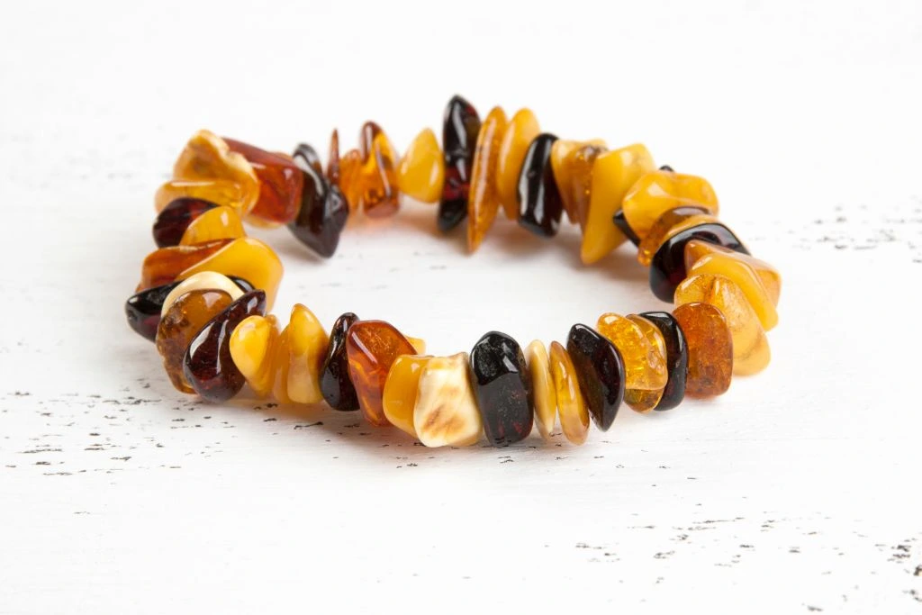 amber bracelet situated on white platform