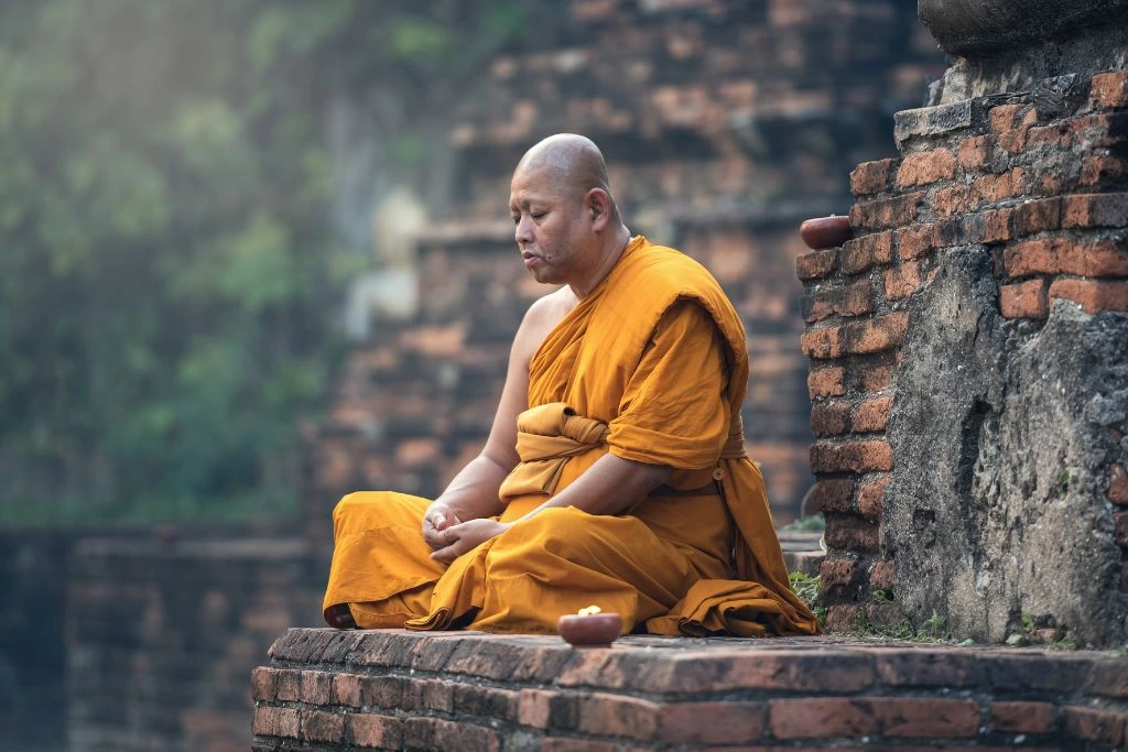 A monk sitting on the floor