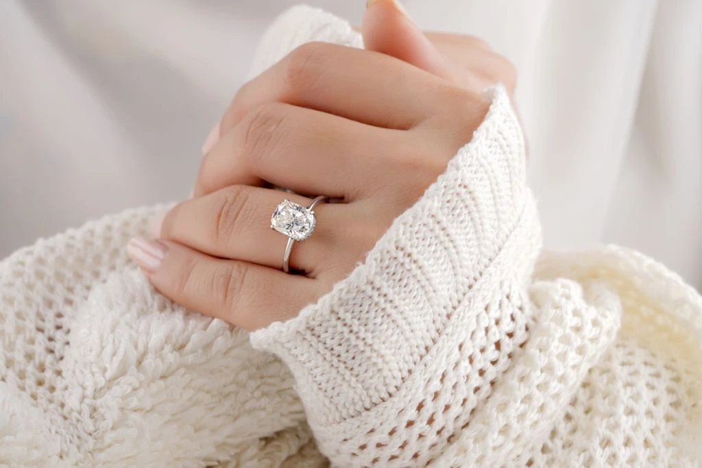 diamond ring worn by a model on her left hand