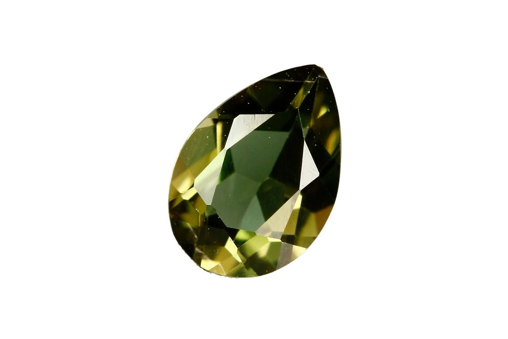 green kornerupine gemstone on a white background