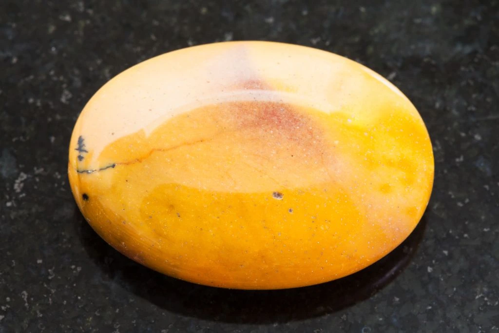 A mookaite crystal on a black granite