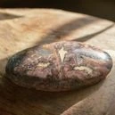 a polished onyx crystal on a wood