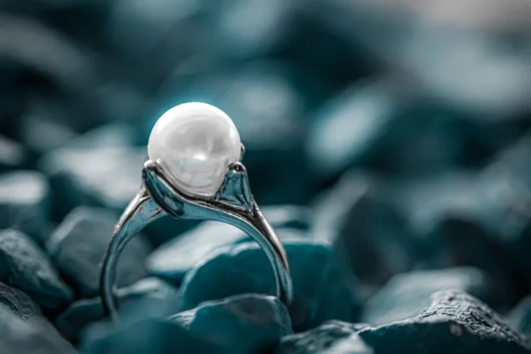 a pearl ring accompanied by blue stones