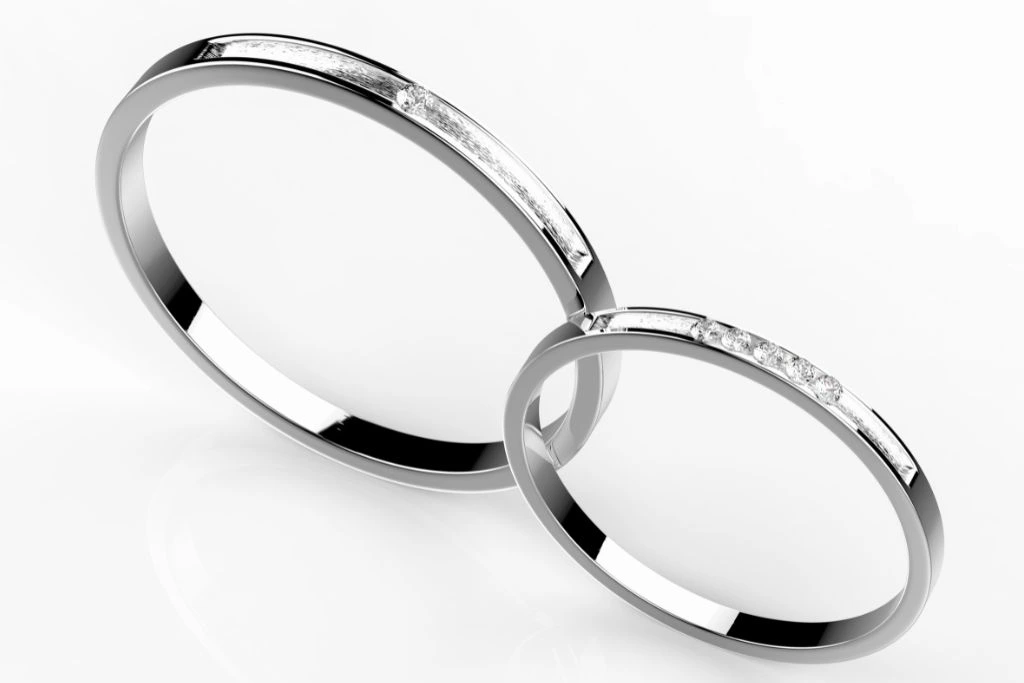 platinum couple ring with diamond stud on grayish background