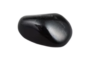 Polished black obsidian crystal on white background