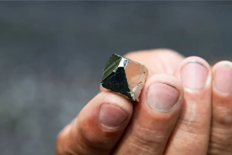 Person holding a pyrite crystal