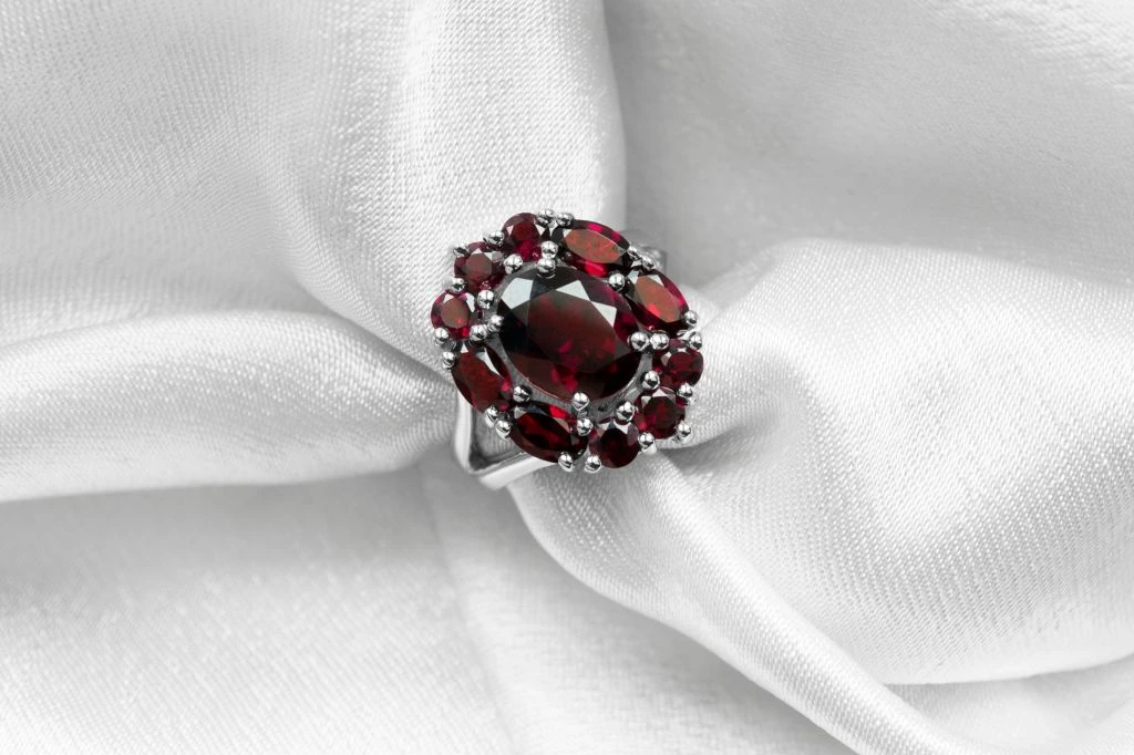 ruby ring placed on top of silky cloth