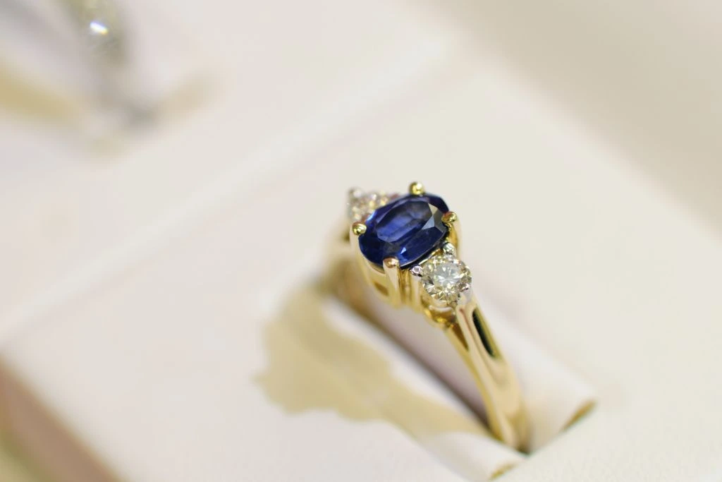 A sapphire ring on a gift box