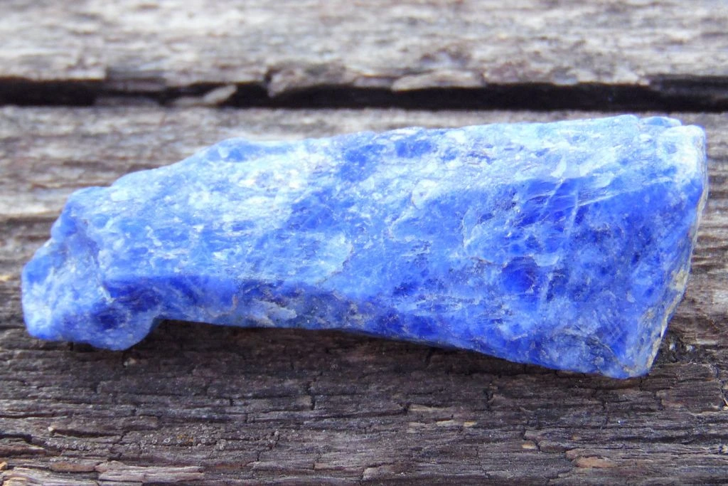 a raw sodalite crystal on a wooden table