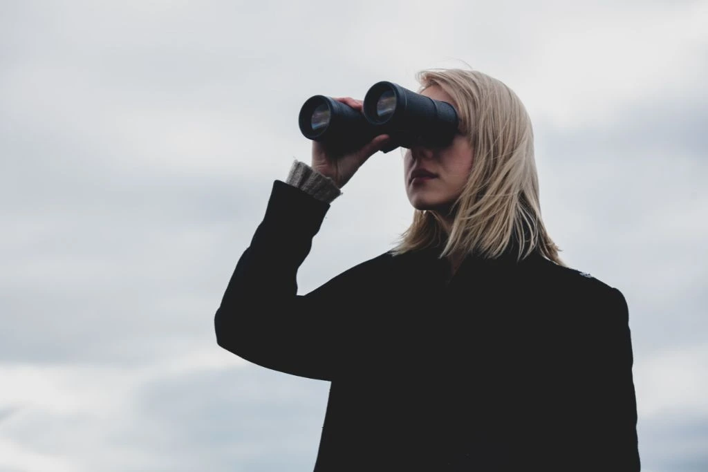 A woman looking through the binoculars