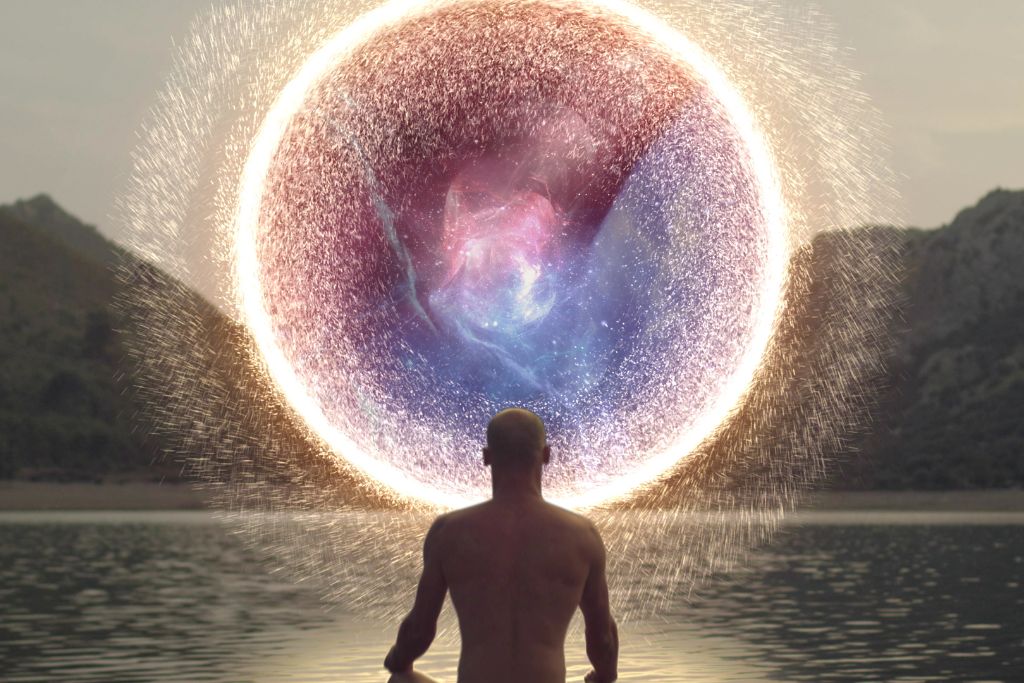 A man meditating in front of a portal