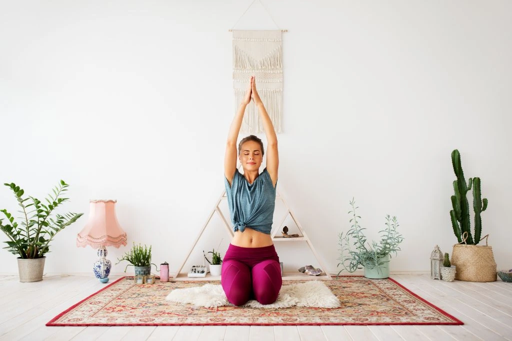 A woman doing a yoga position on a rug