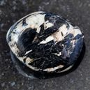Aegirine crystal on a black granite