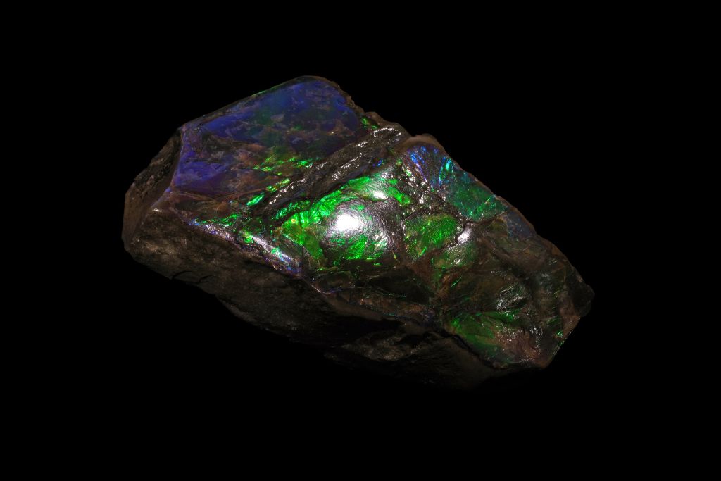 Ammolite crystal on a black background