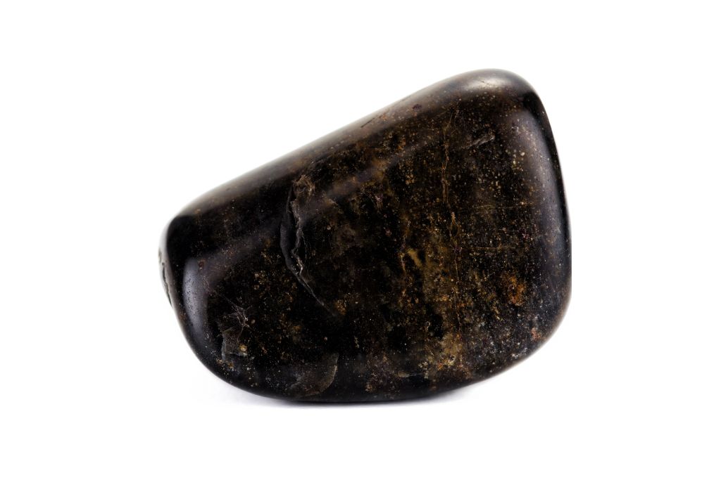 Black jasper crystal on a white background