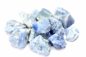 Blue calcite crystals on a white background