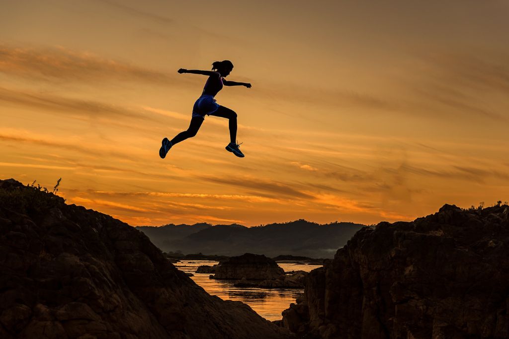 A person in the mid of air jumping from one edge to another