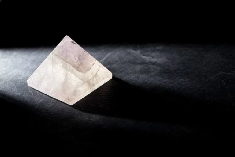 A crystal pyramid on a dark background