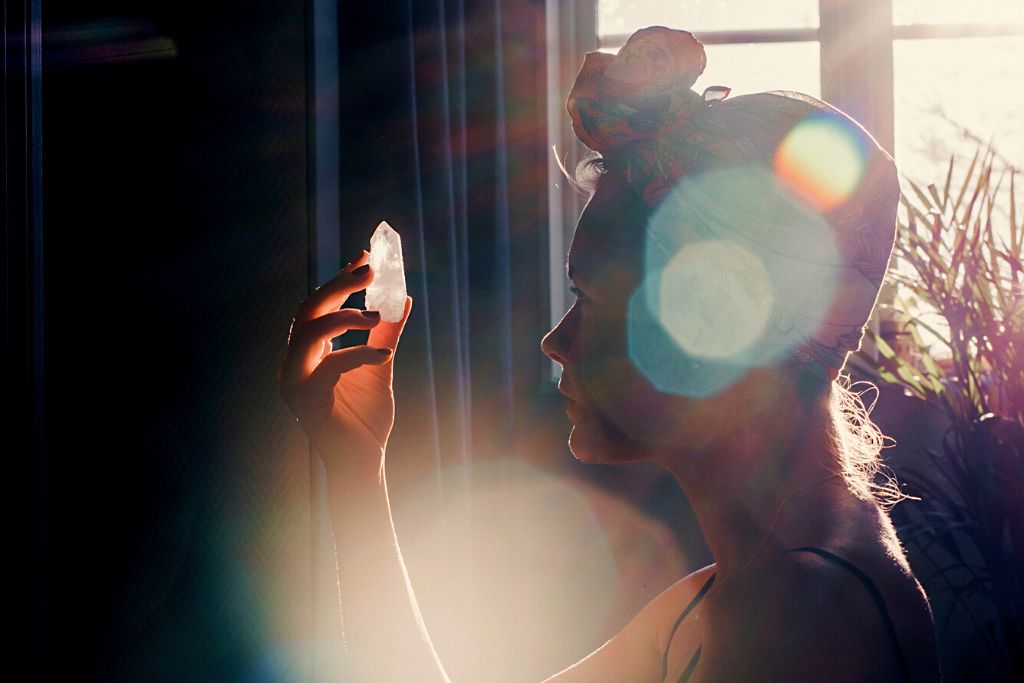 Woman exposing crystal to natural light and starting to program her crystal