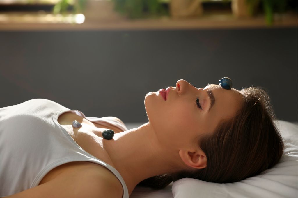 Crystals placed on the body of the woman while doing Reiki programming