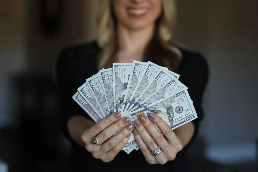 Wealthy woman showing money