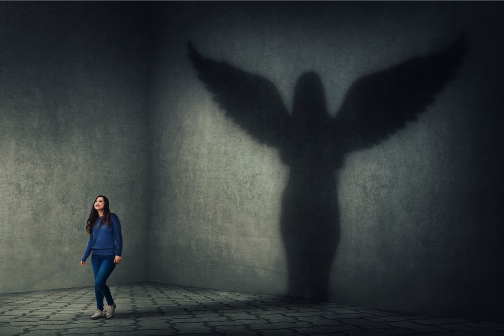A guardian angel shadow behind a woman