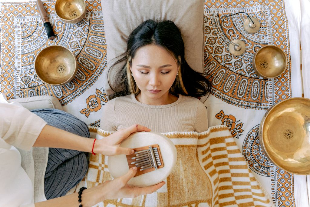 Woman meditating while listening to Kalimba's soothing sound