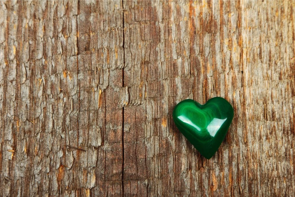 Heart shape Malachite on a wood background