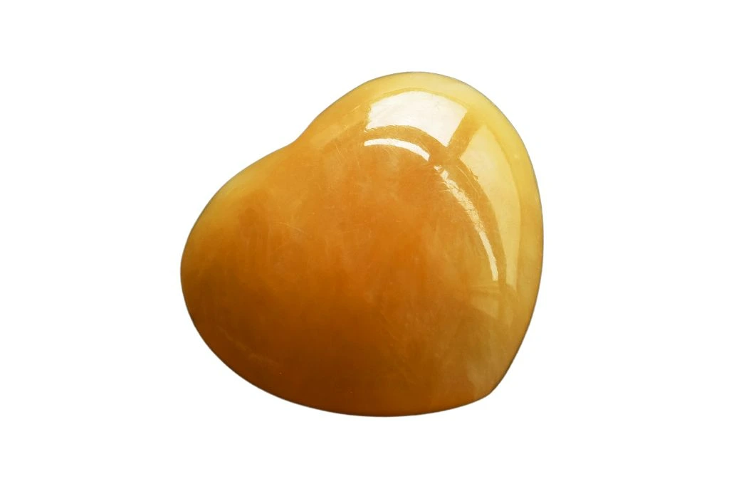 A heart shape citrine crystal on a white background