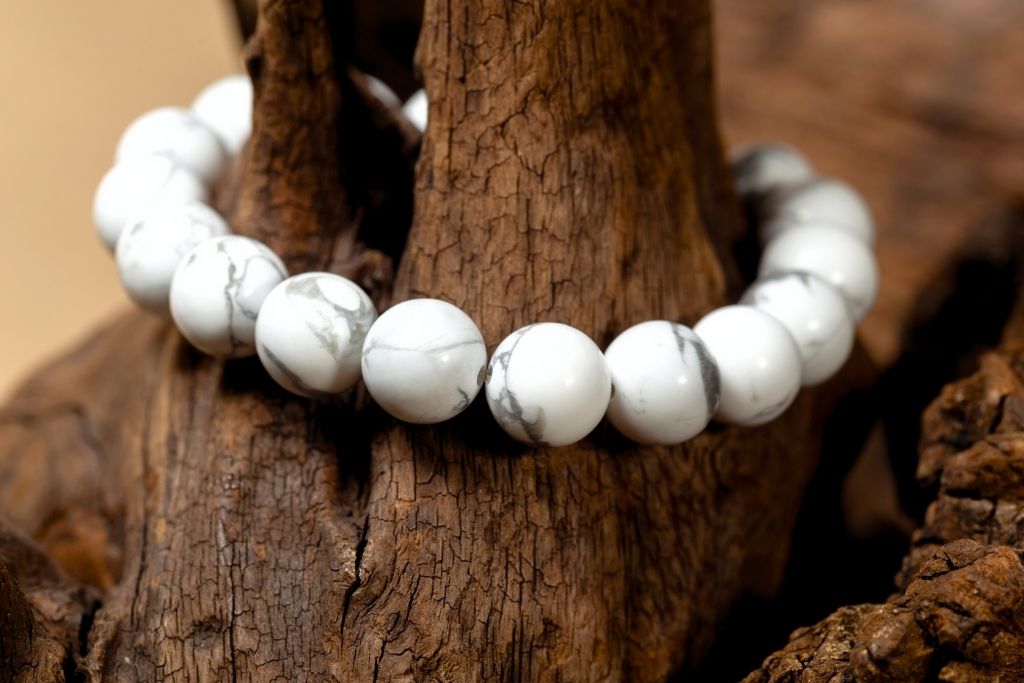 Howlite crystal bracelet placed on a wooden trunk