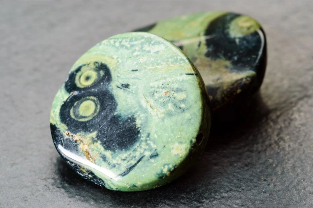 Kambaba Jasper stone on a gray background