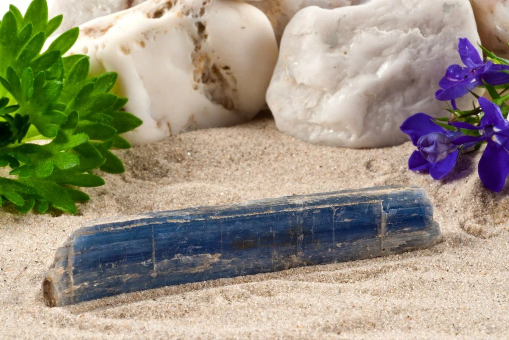 A raw kyanite crystal on the sand