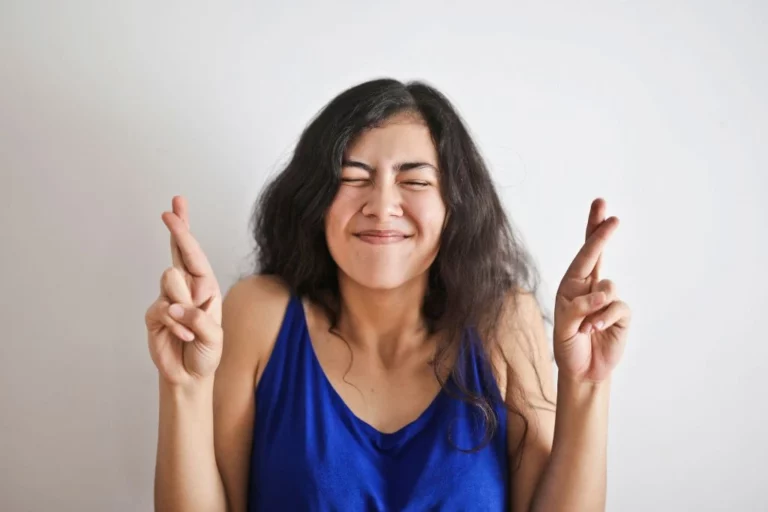 Woman crossing her fingers for luck