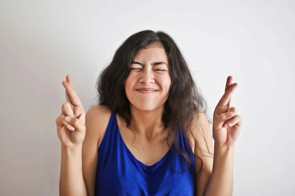 Woman crossing her fingers for luck