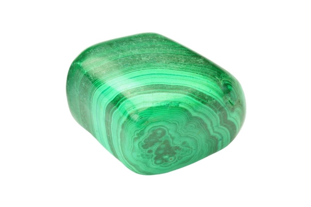 A polished malachite crystal on a white background