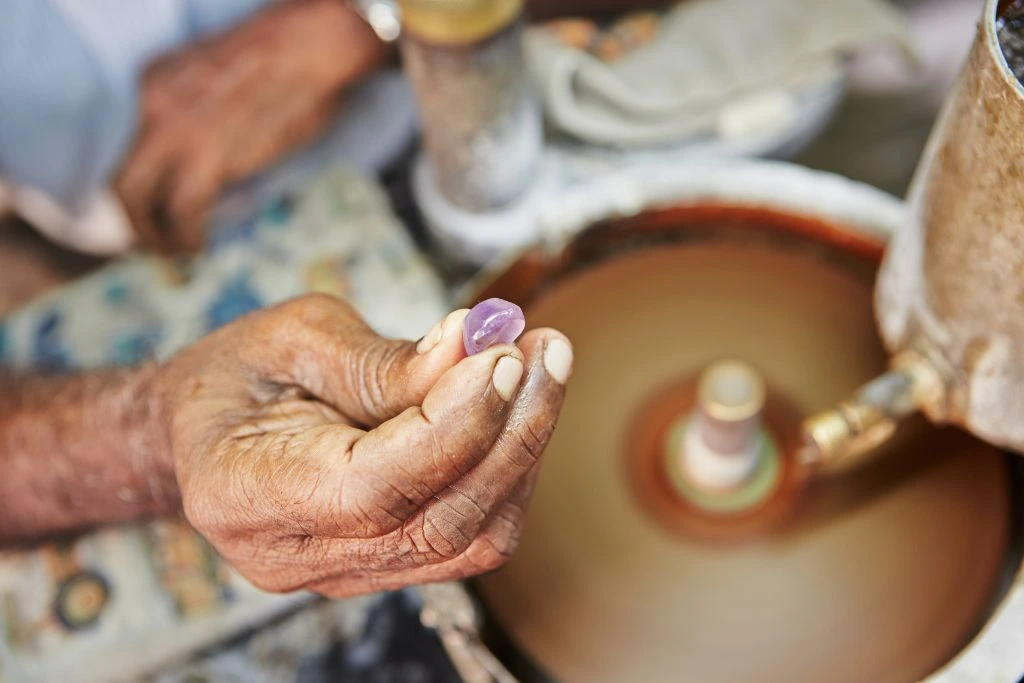 A person holding a moonstone after polishing